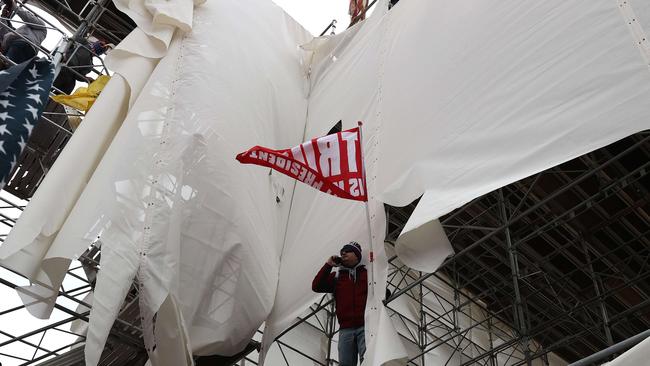 A protester stands on scaffolding outside the US Capitol Building. Picture: AFP.