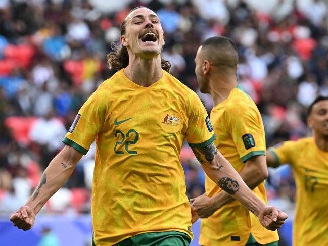 Australia's midfielder #22 Jackson Irvine celebrates after scoring his team's first goal during the Qatar 2023 AFC Asian Cup Group B football match between Australia and India at the Ahmad bin Ali Stadium in Al-Rayyan, west of Doha on January 13, 2024. (Photo by HECTOR RETAMAL / AFP)