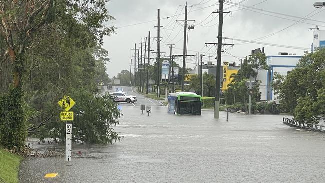 A bus has been swept up in flood waters on the Northern Gold Coast. Picture: Charlton Hart