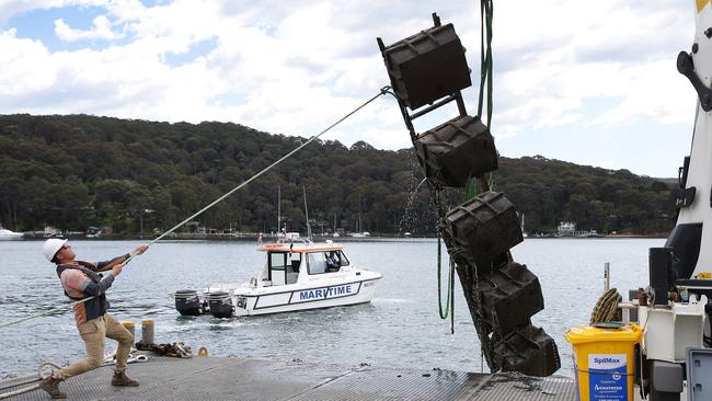 Roads and Maritime Services recovering building materials found in Pittwater, off Scotland Island. Photo Manly Daily