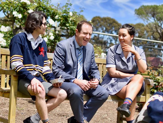 Scotch College principal Scotch College, Adelaide principal John Newton with students Ris Mosel,Amelia Waters and  Hudson Laycock (on the grass facing John). Dr Newton hasbeen principal since 2015. Picture: supplied October 2021 by Hughes PR for Scotch College