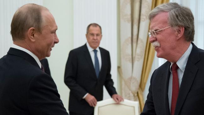 Russian President Vladimir Putin shakes hands with Bolton during the meeting in the Kremlin in 2018.