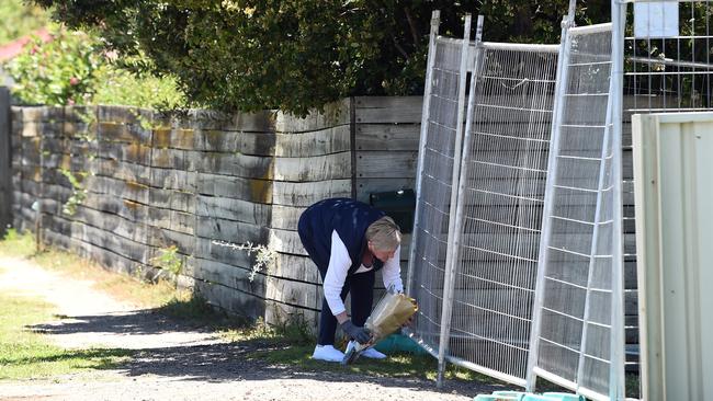 A community member visited the house to lay flowers in tribute. Picture: David Smith