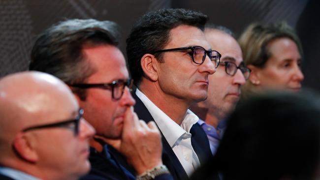 Travis Auld (centre) and Gillon McLachlan after the current chief executive officer announces he will step down from his role at the end of the season.