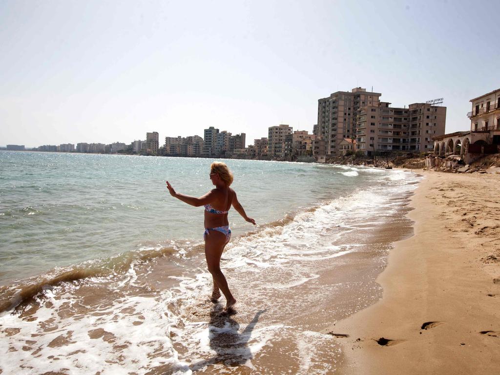 A woman prepares to swim at the beach after the reopening. Picture: Birol Bebek / AFP