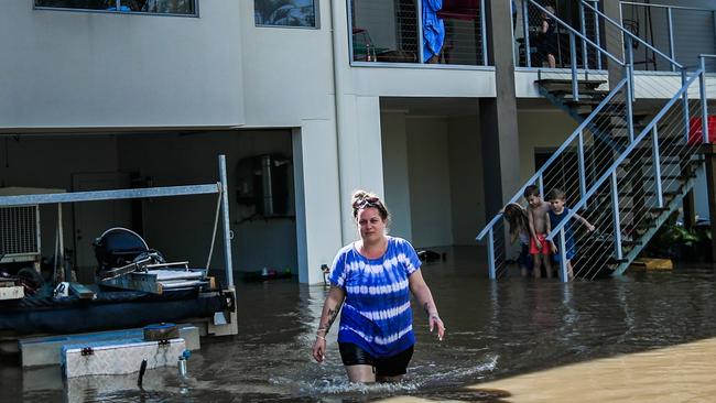 Mother of three Kylie Fulop and partner Ian Foster at their Beenleigh home in Omaru Street which was inundated by the Logan River. Picture: NIGEL HALLETT