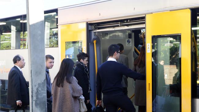 Commuters board a morning train at Ashfield Station. Peak Inner West lines services are approaching 200 per cent capacity.