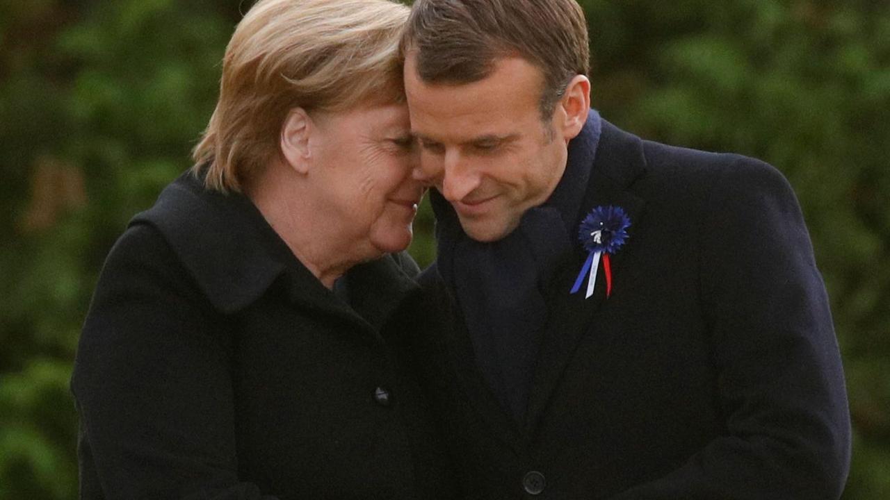 French President Emmanuel Macron and German Chancellor Angela Merkel share a moment after unveiling a plaque in a French-German ceremony. Pic: AFP