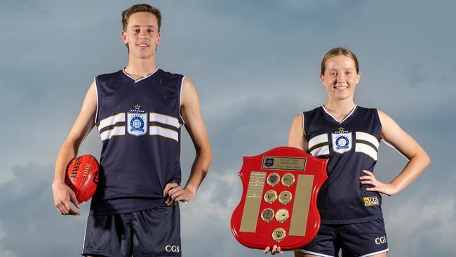 Caulfield premiership footballers Ollie Murphy and Annabelle Embelton pictured ahead of the 2023 school footy. Annabelle is holding the Herald Sun Shield.