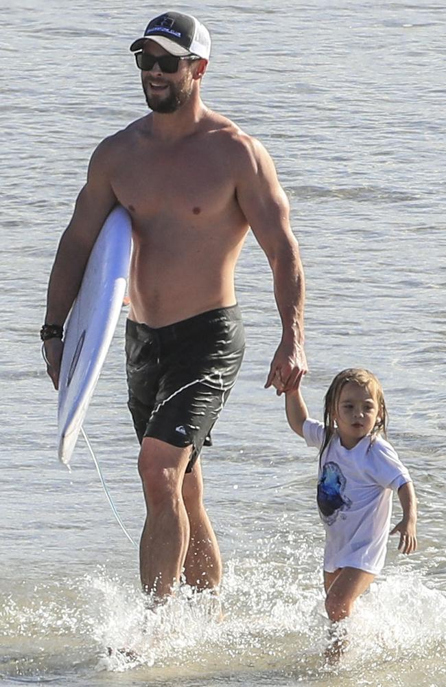 A very buff Chris Hemsworth did some surfing as he looks after two-year-old Sasha. Picture: Media Mode