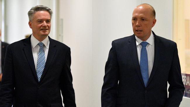 Mathias Cormann and Peter Dutton leave a partyroom meeting at Parliament House after Malcolm Turnbull declared the Liberal leadership vacant in August 2018. Picture: AAP