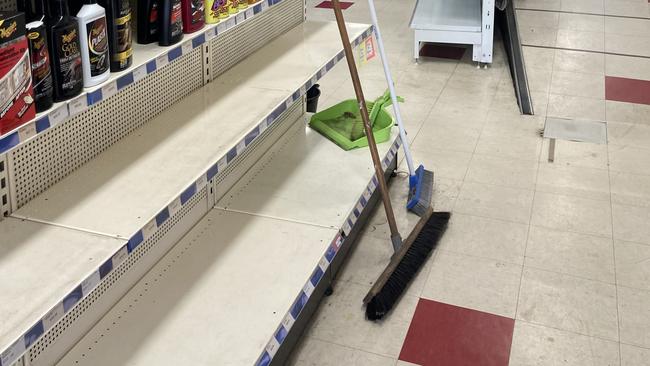 Christine and Mark Campbell are undertaking the arduous process of restocking their shelves after trying to save their products from the predicted flood. Picture: Adelaide Lang