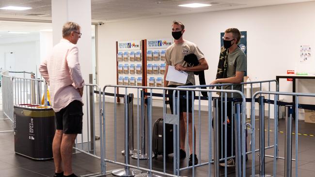 John Bonnin sees his son Tom Bonnin and friend Kale Quinlan before the pair head into mandatory quarantine. Picture: Che Chorley