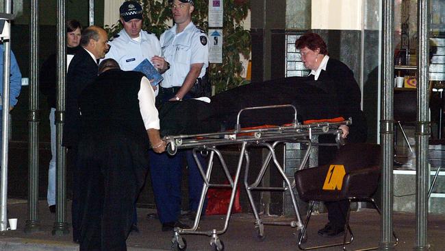 Lewis Moran’s body is wheeled out of the Brunswick Club, almost 20 years to the day. Picture: Ellen Smith
