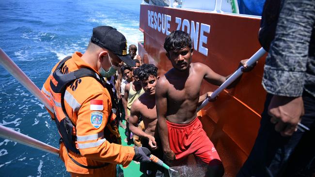 Rohingya refugees board a National Search and Rescue Agency vessel off west Aceh. Picture: AFP