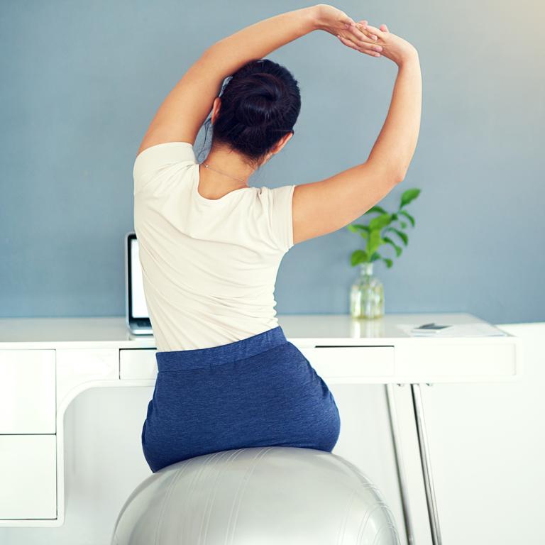 Simply swap out your chair and spend half your day on an exercise ball so you sit upright using your legs. Picture: iStock