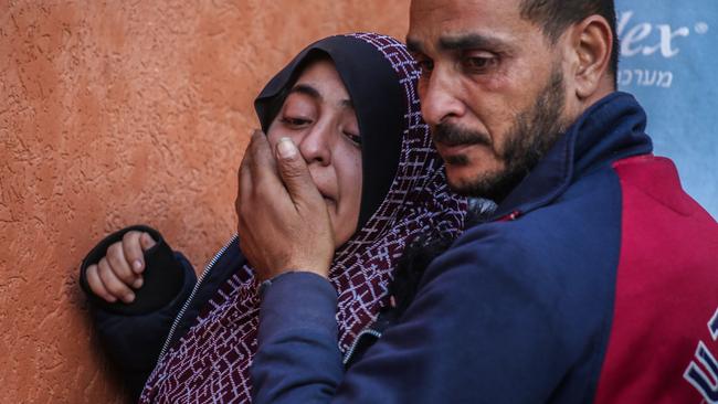 Parents mourn as they collect the bodies of their children in an air strike. Picture: Ahmad Hasaballah