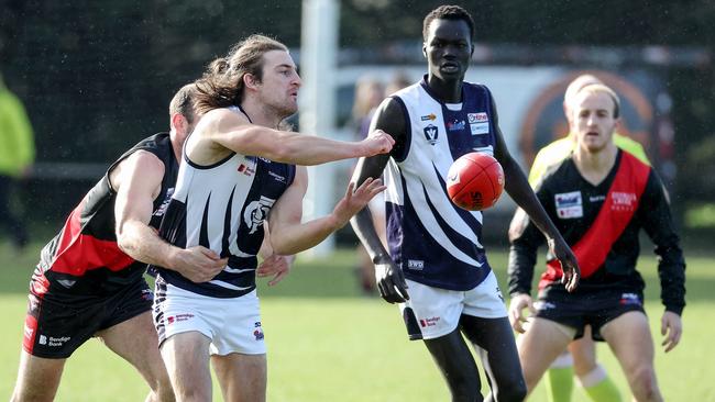 RDFL: Melton Centrals’ Connor Charge gets a handball away. Picture: George Sal