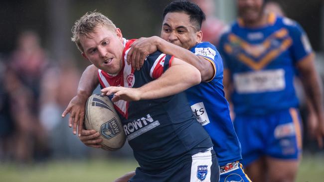 Jackson Willis is tackled by Kangaroos Alex Seve. News Local, Pictures by Julian Andrews.