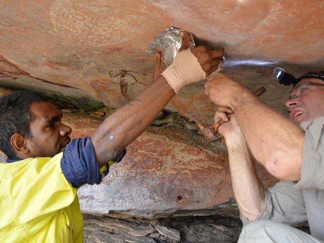 Traditional Owner Lucas Karadada and Damien Finch collecting a sample for Radiocarbon Dating. Picture: Pauline Heaney Images supplied by Rock Art Australia Photo credit: Balanggarra Aboriginal Corporation