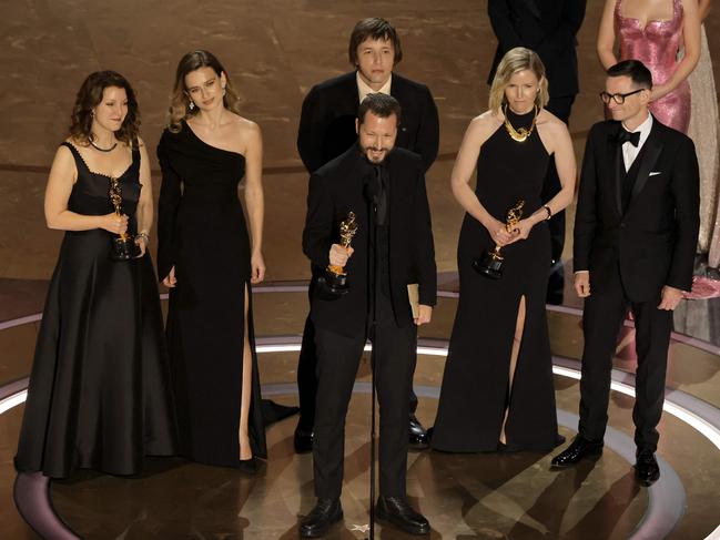 Raney Aronson-Rath, Mstyslav Chernov and Michelle Mizner accept the Best Documentary Feature Film for "20 Days in Mariupol". Picture: Getty Images via AFP