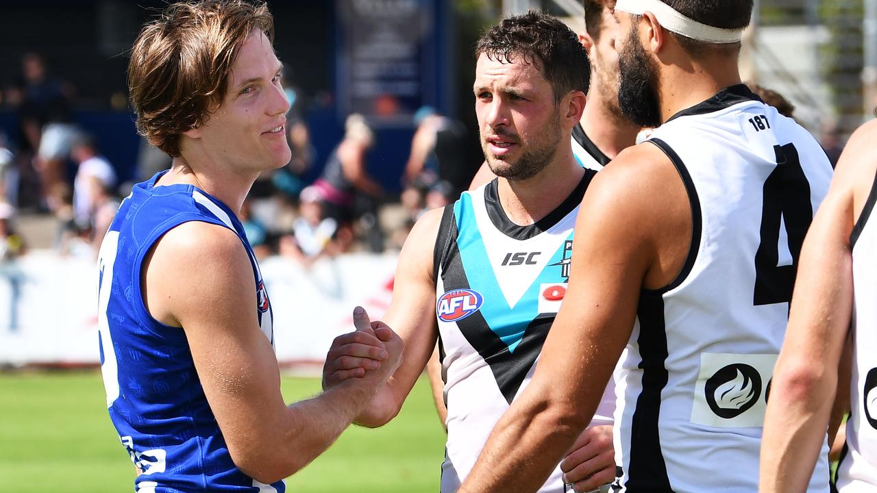 Jared Polec shakes hands with former teammates Travis Boak and Paddy Ryder.