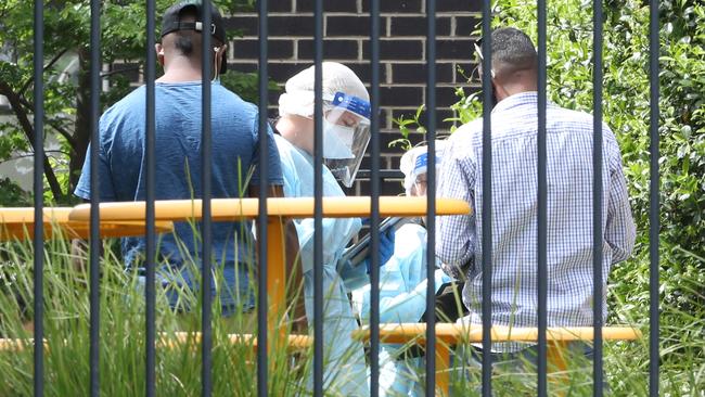 Residents and medical staff outside a public housing block in Broadmeadows. Picture: David Crosling