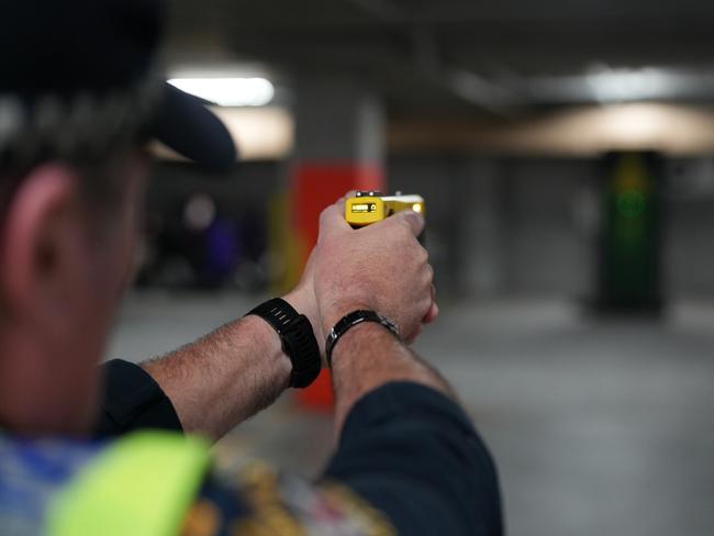 Tasmania Police Constable Paul Bennett fires a Taser weapon.