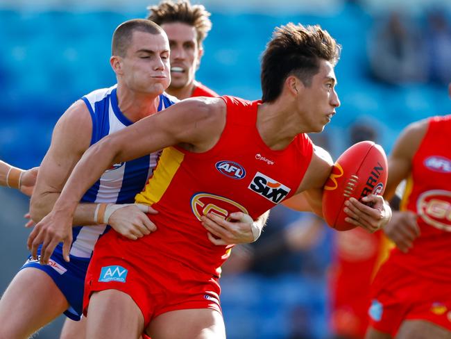 HOBART, AUSTRALIA - AUGUST 26: Alex Davies of the Suns is tackled by Bailey Scott of the Kangaroos during the 2023 AFL Round 24 match between the North Melbourne Kangaroos and the Gold Coast SUNS at Blundstone Arena on August 26, 2023 in Hobart, Australia. (Photo by Dylan Burns/AFL Photos via Getty Images)