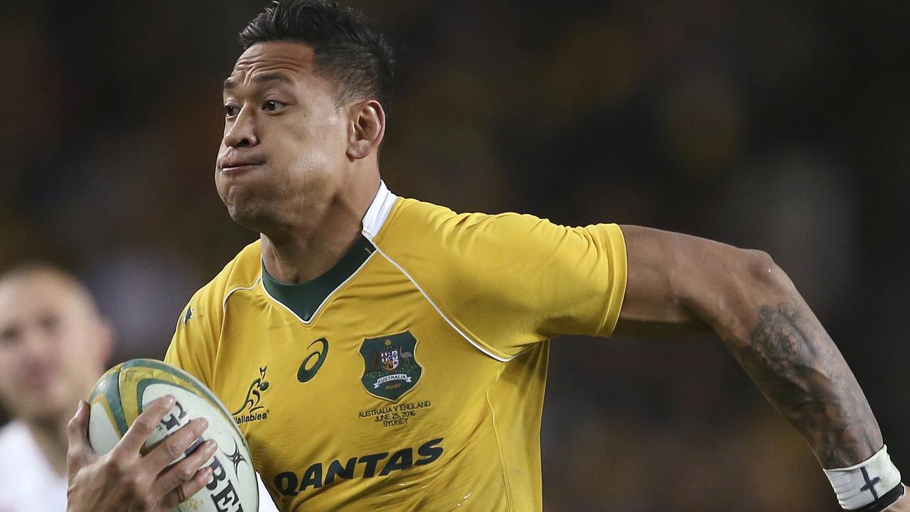 FILE - In this June 25, 2016, file photo, Australian rugby union player Israel Folau, wearing tape on his wrist adorned with a cross, runs toward the try line to score against England during their rugby union test match in Sydney. The 30-year-old Folau will appear before a code of conduct hearing at Rugby Australia's headquarters in Sydney to determine the playing future of the star Wallabies fullback on Saturday, May 4, 2019. (AP Photo/Rick Rycroft, File)