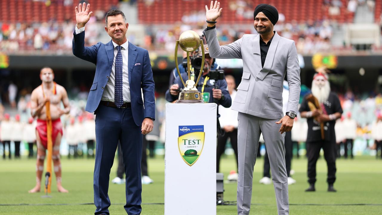 ADELAIDE, AUSTRALIA - DECEMBER 06: Ricky Ponting and Harbhajan Singh wave to the crowd next to the Border-Gavaskar Trophy prior to day one of the Men's Test Match series between Australia and India at Adelaide Oval on December 06, 2024 in Adelaide, Australia. (Photo by Robert Cianflone/Getty Images)