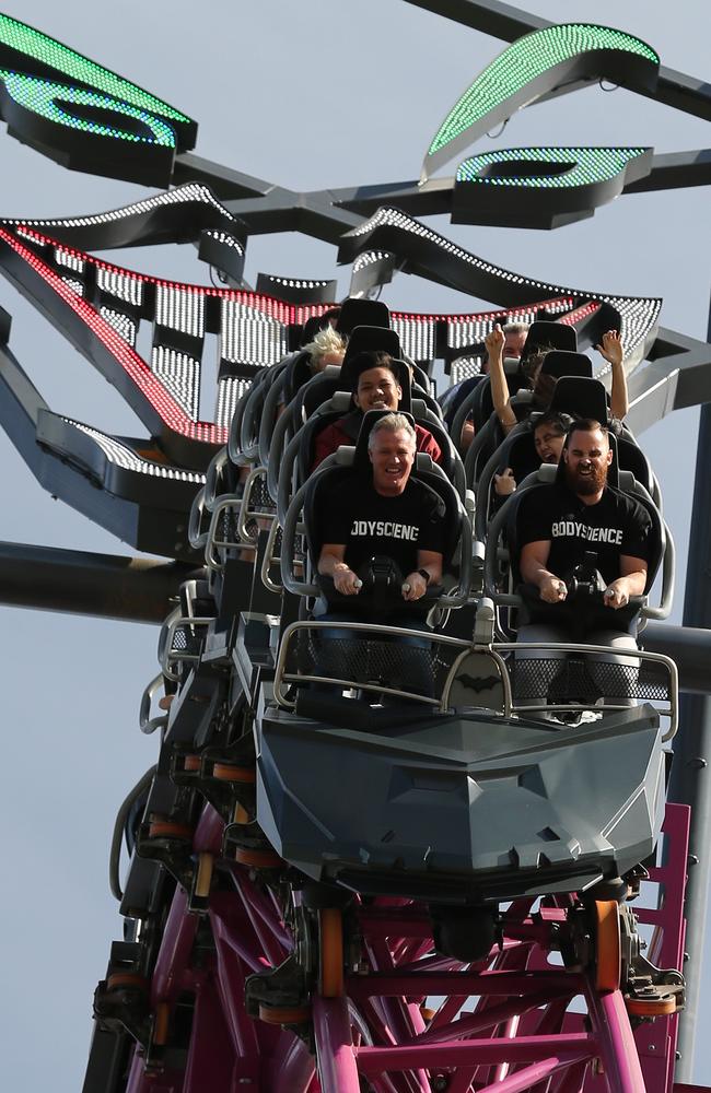 Pictued at Movie World Titans coach Garth Brennan and first cheque donator Joel Dening of Body Science on a roller coaster. Picture Mike Batterham