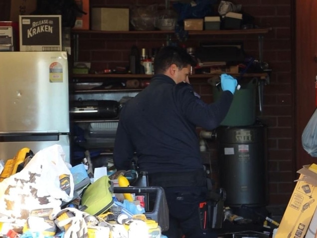 Police search the Malvern East home where Hourigan lived.