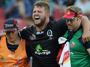 Reds James Slipper reacts after being injured during the Super XV rugby match between Lions and Reds at Ellis Park rugby stadium on March 18, 2017 in Johannesburg. / AFP PHOTO / STRINGER