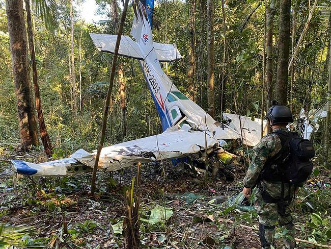 A soldier standing next to the wreckage of an aircraft that crashed in the Colombian Amazon forest in the municipality of Solano, department of Caqueta, on May 19. Picture: AFP