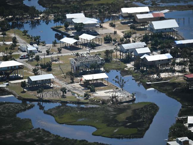 TOPSHOT - A view of damaged homes affected by Hurricane Helene near Keaton Beach, Florida, on October 3, 2024, as Marine One and US President Joe Biden take an aerial tour of the area. (Photo by Mandel NGAN / AFP)