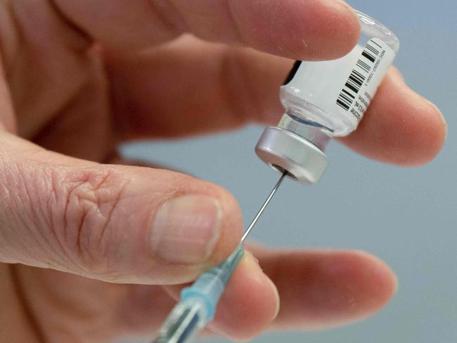 Medical personnel prepares a syringe with the Pfizer-BioNTech vaccine against Covid-19 at the pharmacy of the vaccination center at the Robert Bosch hospital in Stuttgart, southern Germany, on February 12, 2021. (Photo by THOMAS KIENZLE / AFP)