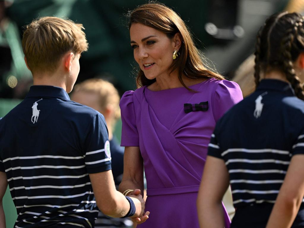 Catherine, Princess of Wales (C) shakes hands with ballboys as she attends the trophy ceremony at the end of the men's singles final tennis match. Picture: AFP