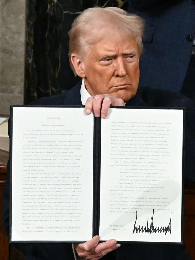 US President Donald Trump holds up an executive order that renames a wildlife sanctuary in honour of the late Jocelyn Nungaray, a 12 year-old girl who was murdered by two undocumented migrants. Picture: AFP