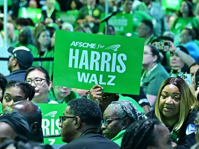 Supporters hold signs as Minnesota Governor and Democratic vice presidential candidate Tim Walz speaks at the AFSCME Convention at the Los Angeles Convention Center. Picture: AFP