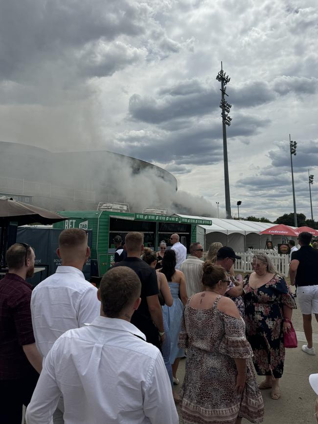 Racegoers could see smoke and ash from the fire. Picture: Supplied