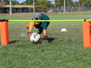 GOING UNDER: Mitch and Natalie De Rossi help Gayndah's junior touch players brush up on their skills.