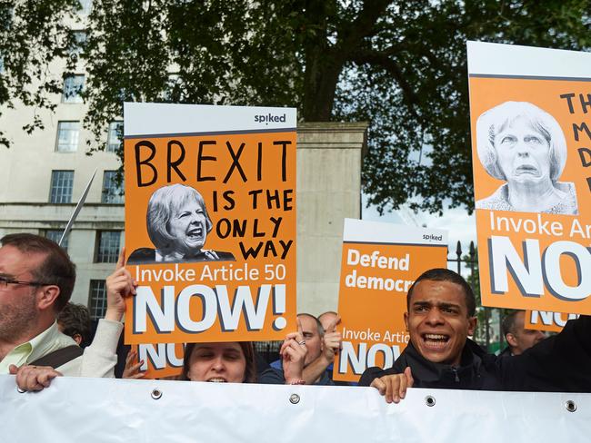 Getting on the smashglobalisation express. Pro-Brexit supporters hold up placards as they demonstrate outside Downing street in central London on July 13, 2016. Picture: Niklas Hallen.