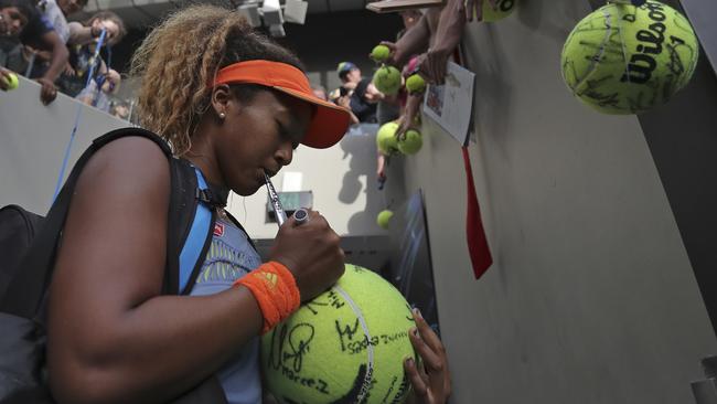 Ash Barty’s conqueror, Japan's Naomi Osaka, signs autographs for fans. Photo: AP