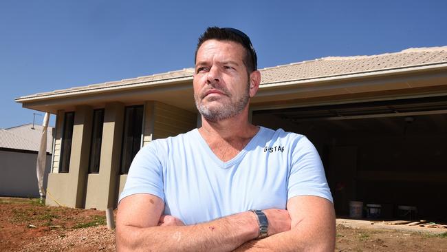 Rod Mattingley poses for the camera ouside his half finished home in Griffin. Rod Mattingley with his botched Q1 Homes house which is now being comlpeted by related company Empire Constructions. Wednesday September 20, 2017. (AAP image, John Gass)