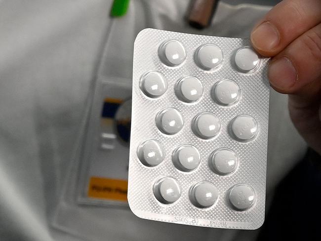 Medical staff shows on February 26, 2020 at the IHU Mediterranee Infection Institute in Marseille, packets of a Nivaquine, tablets containing chloroquine and Plaqueril, tablets containing hydroxychloroquine, drugs that has shown signs of effectiveness against coronavirus. - The Mediterranee infection Institute in Marseille based in La Timone Hospital is at the forefront of the prevention against coronavirus in France. (Photo by GERARD JULIEN / AFP)