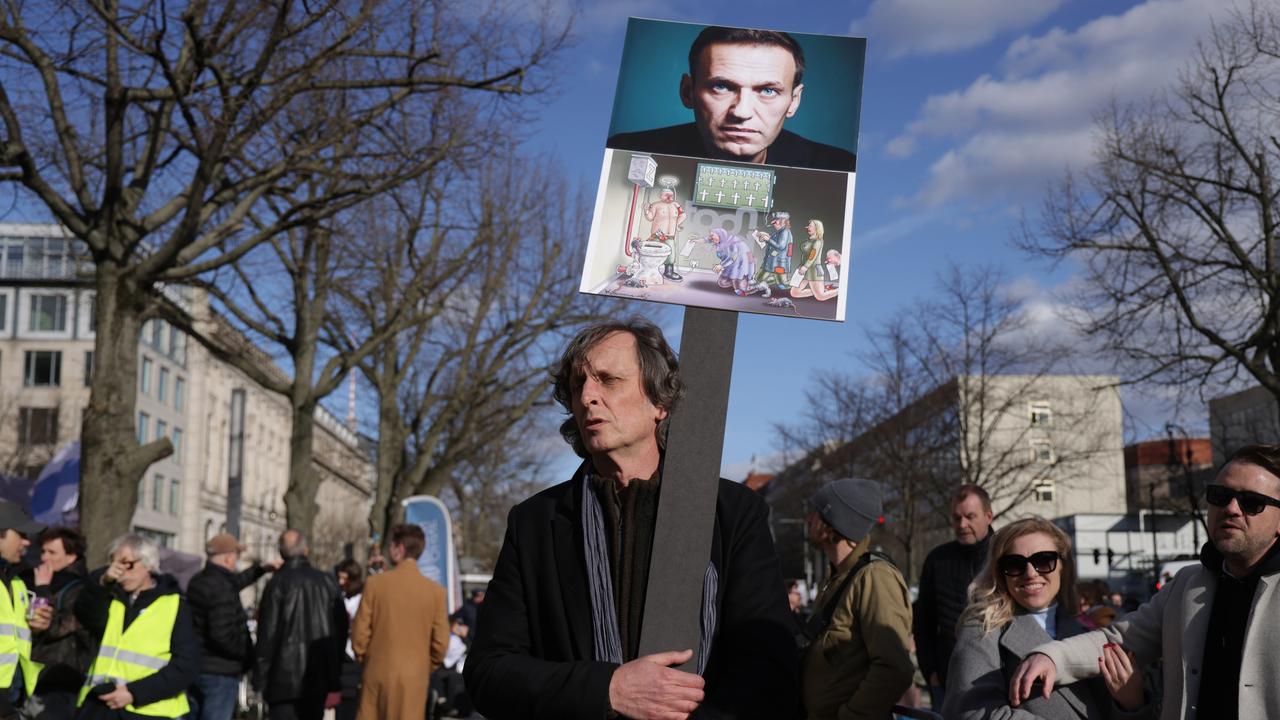 A demonstrator holds a placard showing late Russian opposition figure Aleksei Navalny during a protest outside the Russian Embassy in Berlin, Germany. Picture: Sean Gallup/Getty Images