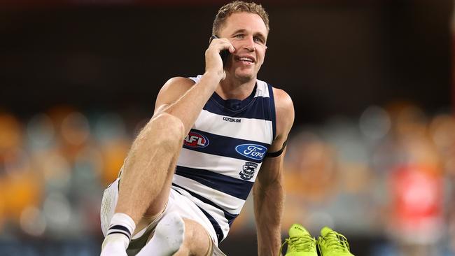 Mobile phones are a constant at clubs as Joel Selwood does an interview on the phone.