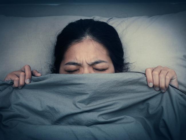 This young woman does not want to hear sound from alarm clocks. Sleep chemical melatonin kicks in later at night for adolescent than it does for adults, so they sleep in. Picture: iStock