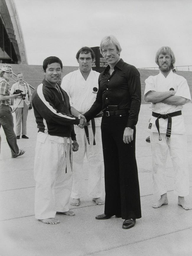 Brooks (middle) with two of his fellow sensei’s meeting Chuck Norris at the Sydney Opera House. Supplied.